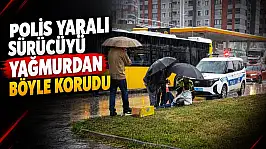 Polis Yaralı Sürücüyü Yağmurdan Böyle Korudu!